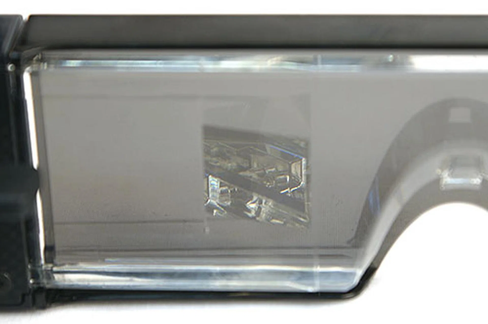 At an angle, you can catch a glimpse of the half-mirror/projection lens system within.