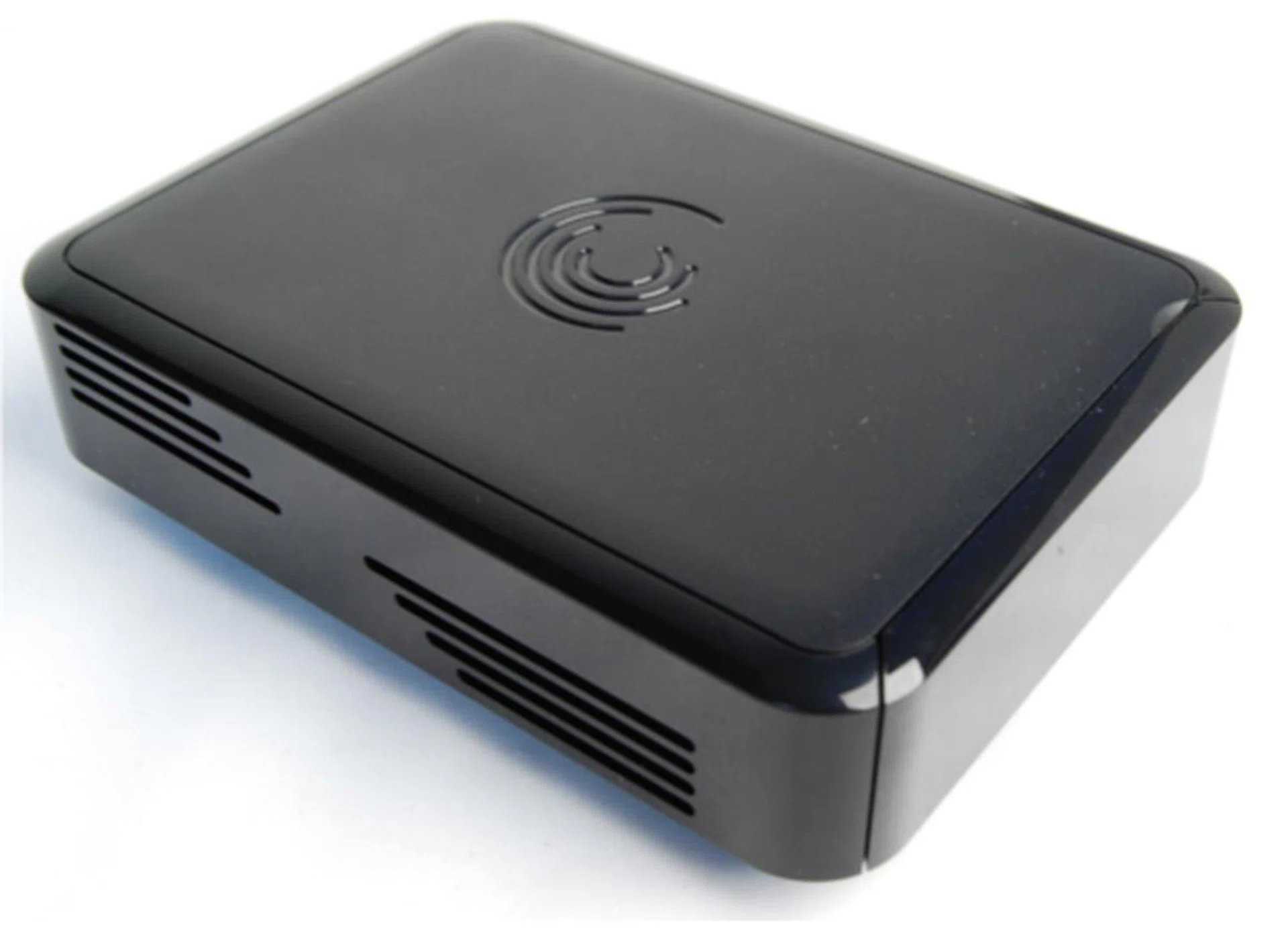 The Seagate FreeAgent GoFlex TV is a fingerprint magnet with its glossy look and feel. The front face is facing southeast in this picture, which means what you see here are the vents on the sides of the media player.