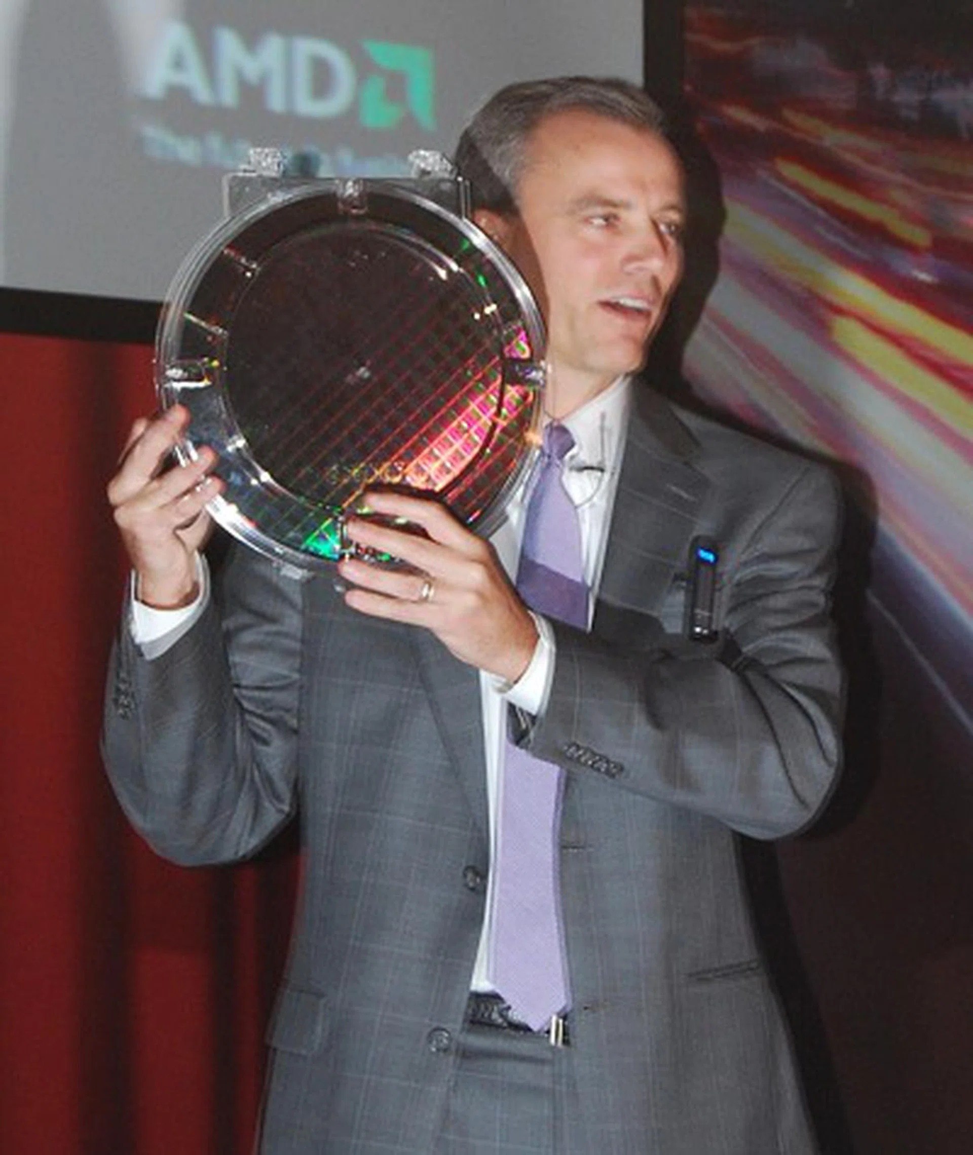 The first Llano APU 32nm SOI wafer held up by Chris Cloran, Corporate VP and GM of AMD's Client Division.
