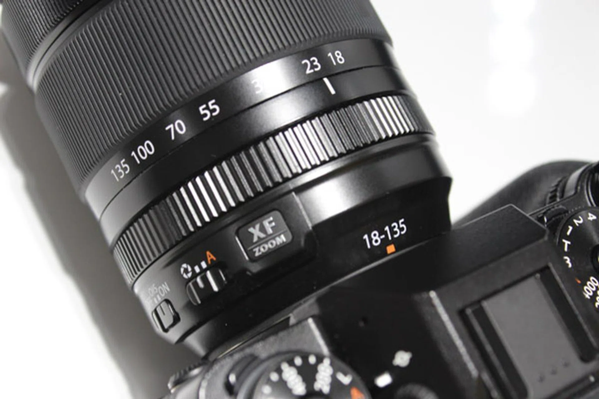 Note the switch for aperture dial, and the lack of a distance meter on the lens.