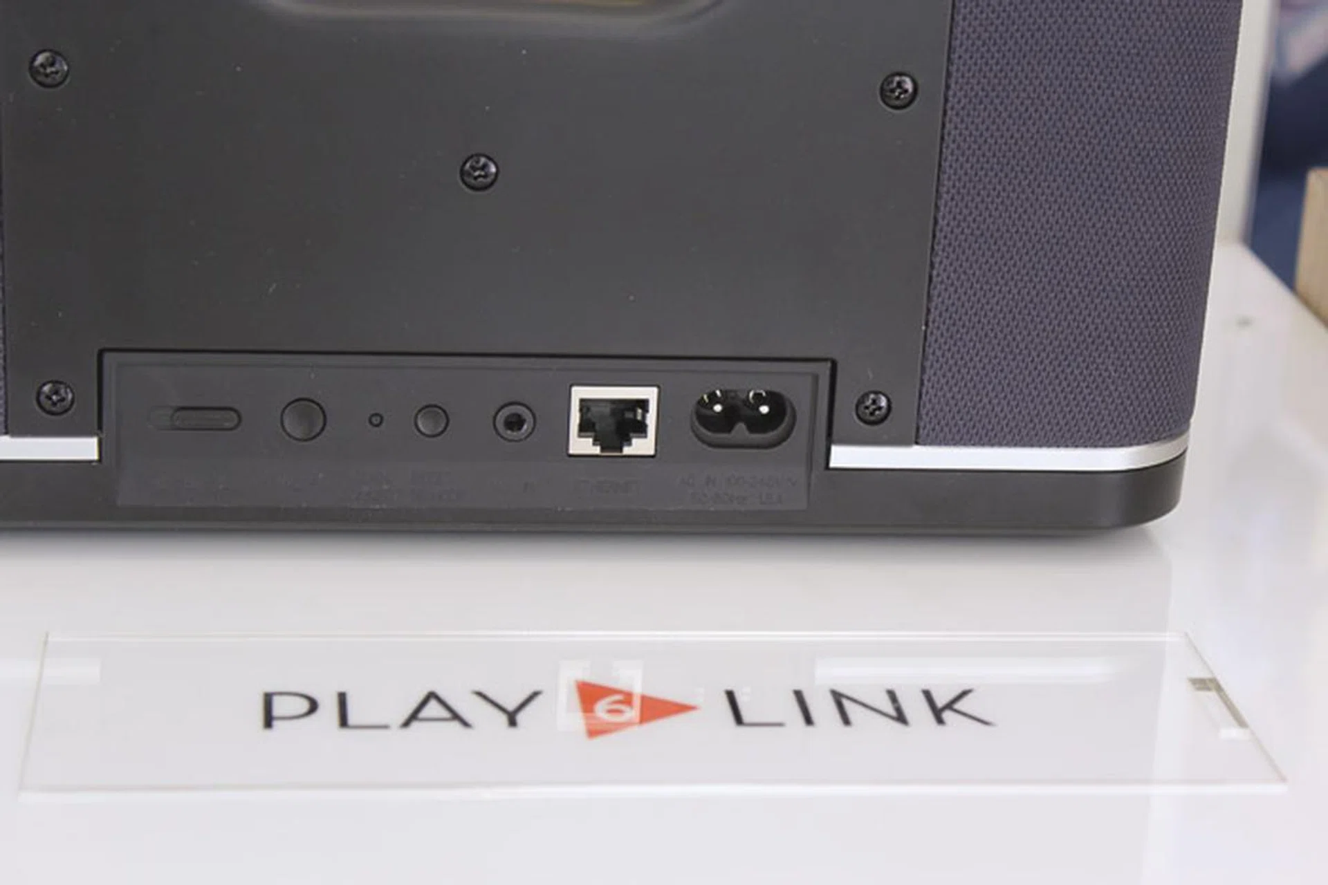 Same number of ports behind, but notice the switch that lets you select the channel the speaker plays (L,R or Centre).