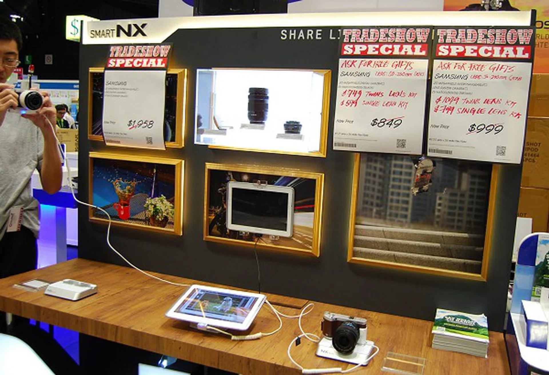 Samsung's NX series of cameras shown here in an artistic setting along with their ecosystem of products to promote "smart" interaction.