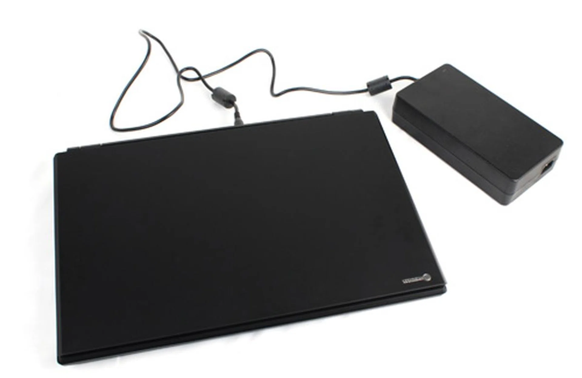 The Titan alongside its massive power brick. The brick alone weighs more than most Ultrabooks.