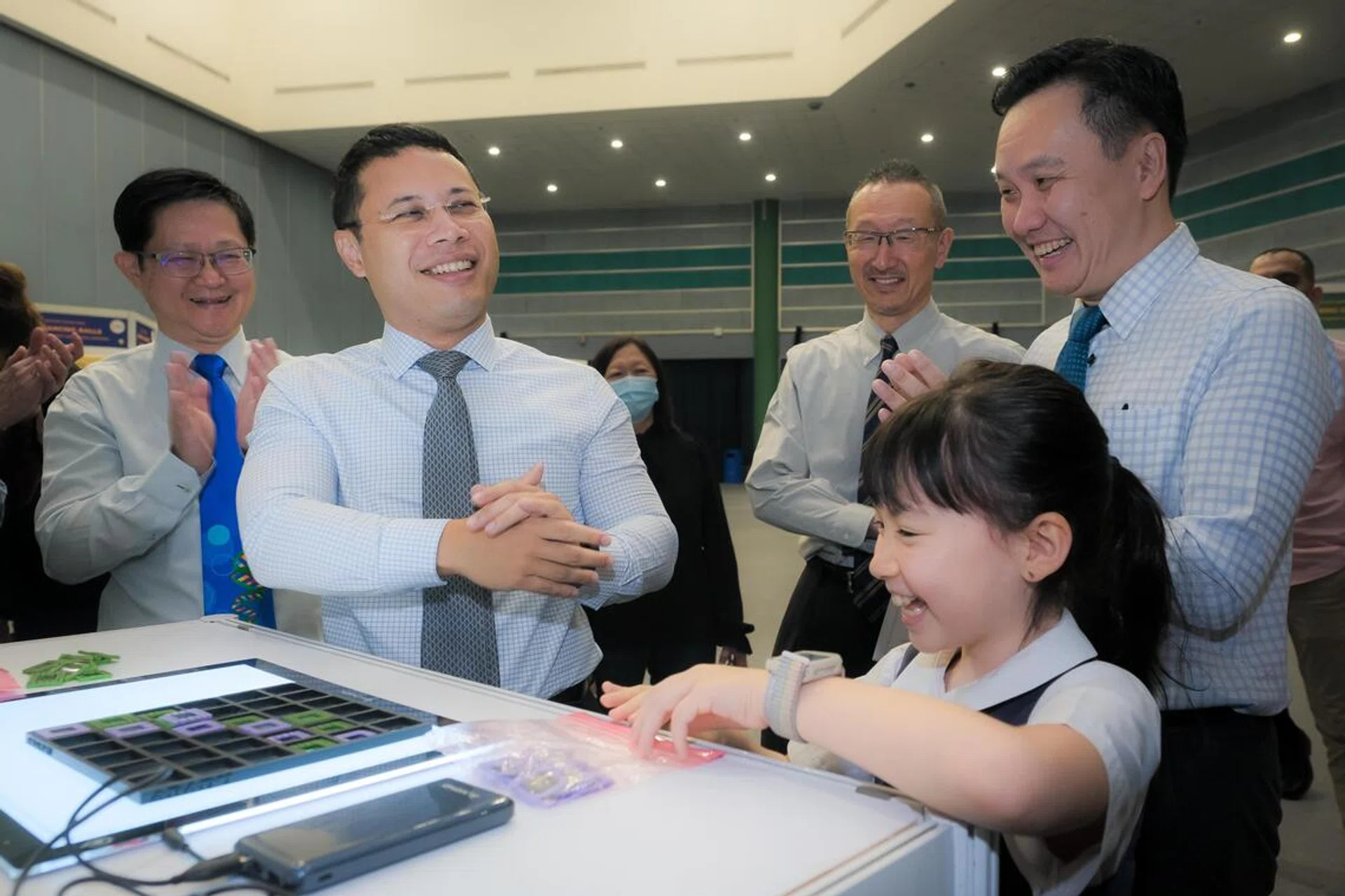 From left: Science Centre Singapore chief executive Associate Professor Lim Tit Meng, Minister for National Development Desmond Lee, Sony Electronics Asia Pacific managing director Takakiyo Fujita and SCSA2022 Committee chairman Dr Fannon Lim with Raffles Girls' Primary School pupil Abbie Yuhan Milner and her invention Abadu, while touring exhibition booths at the Sony Creative Science Award presentation held at the Science Centre, 8 Nov 2022.