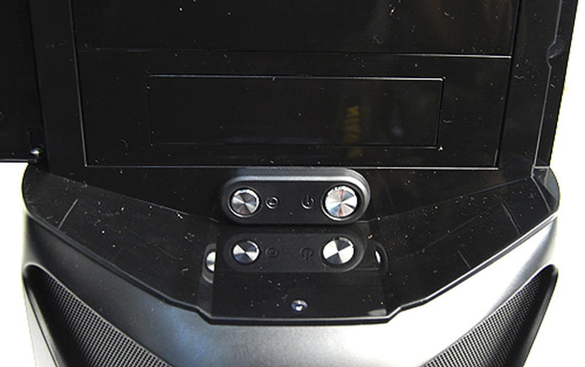 The power and reset buttons are needlessly concealed behind a protective plastic cover.