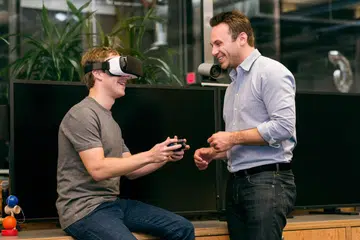 Mark Zuckerberg trying out the Samsung VR headgear, a mobile VR headset that's powered by Oculus. Oculus was bought by Facebook two years ago.