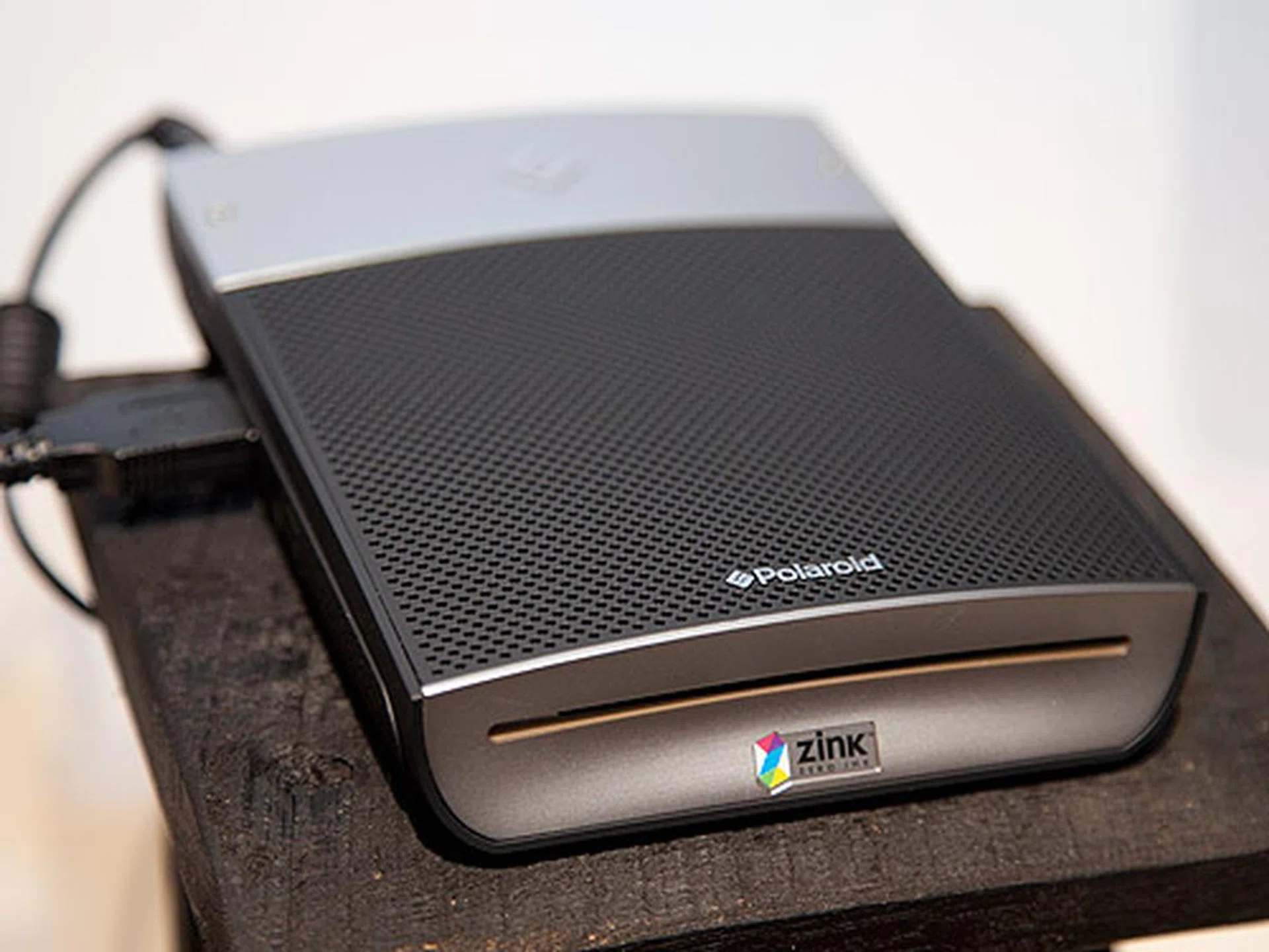 Polaroid's new GL10 Instant Mobile Printer prints color images either wirelessly through Bluetooth using mobile phones or most digital cameras through the USB cable. It uses their proprietary ZINK Paper which has embedded dye crystals. 