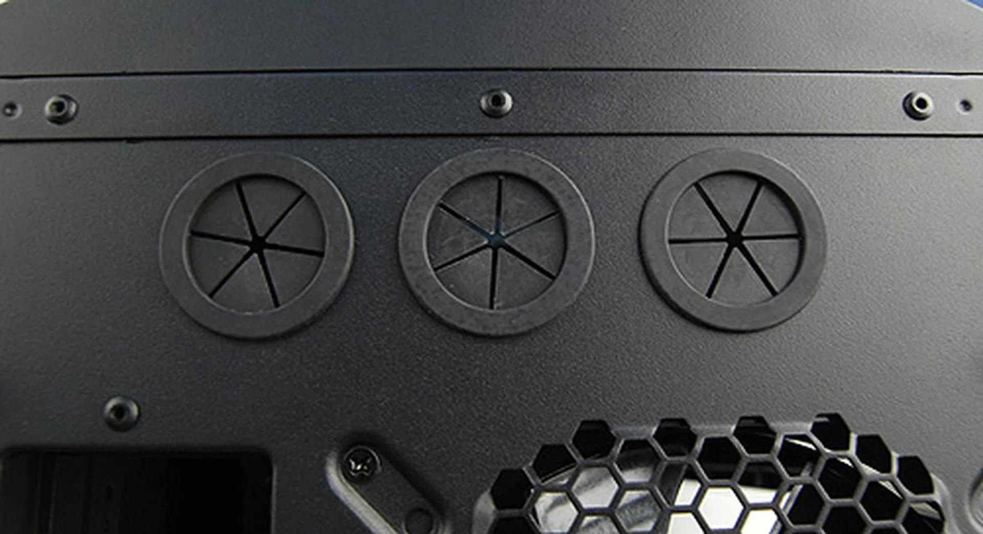 A closer look at the three grommets for liquid-cooling setups. The additional third grommet can be used to route cables required to activate the USB 3.0 ports on the front I/O panel.