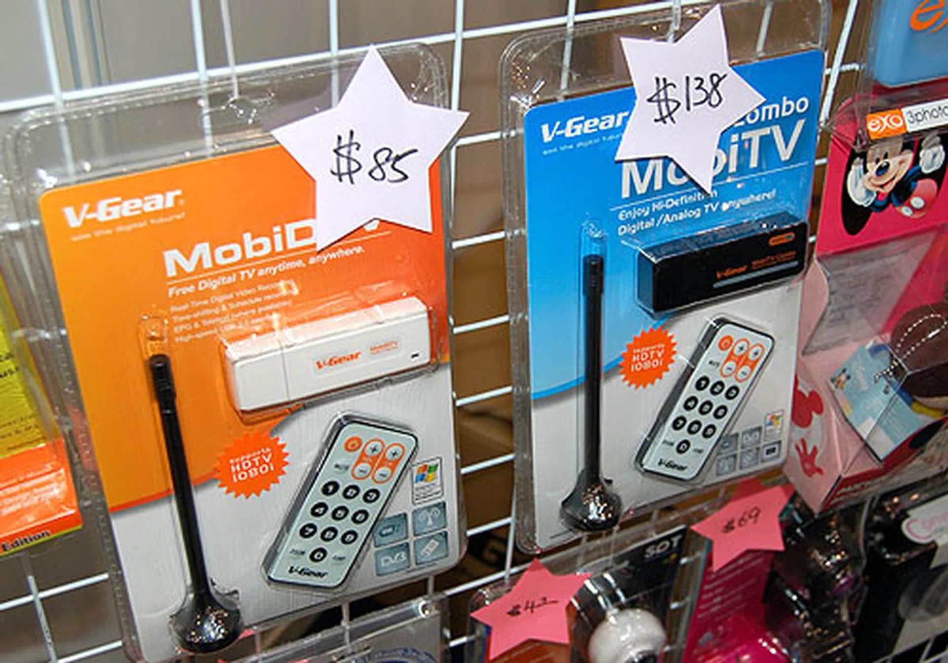 Digital and analog TV tuners from V-Gear. The pure Digital version costs S$85 while the one with analog options is S$138. Both come with a tiny little remote.