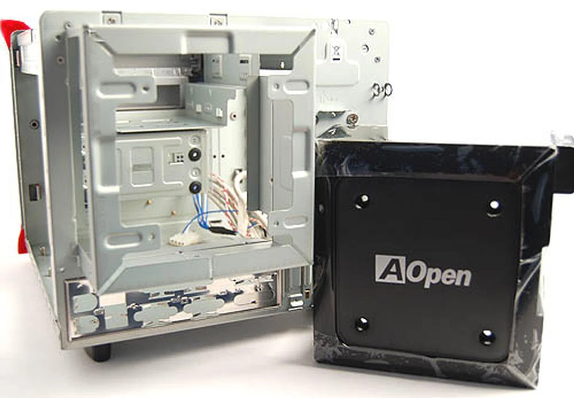 You'll need to remove the plastic shroud, then the metal cage before you can start installing the PSU. More screws await your attention for this process.