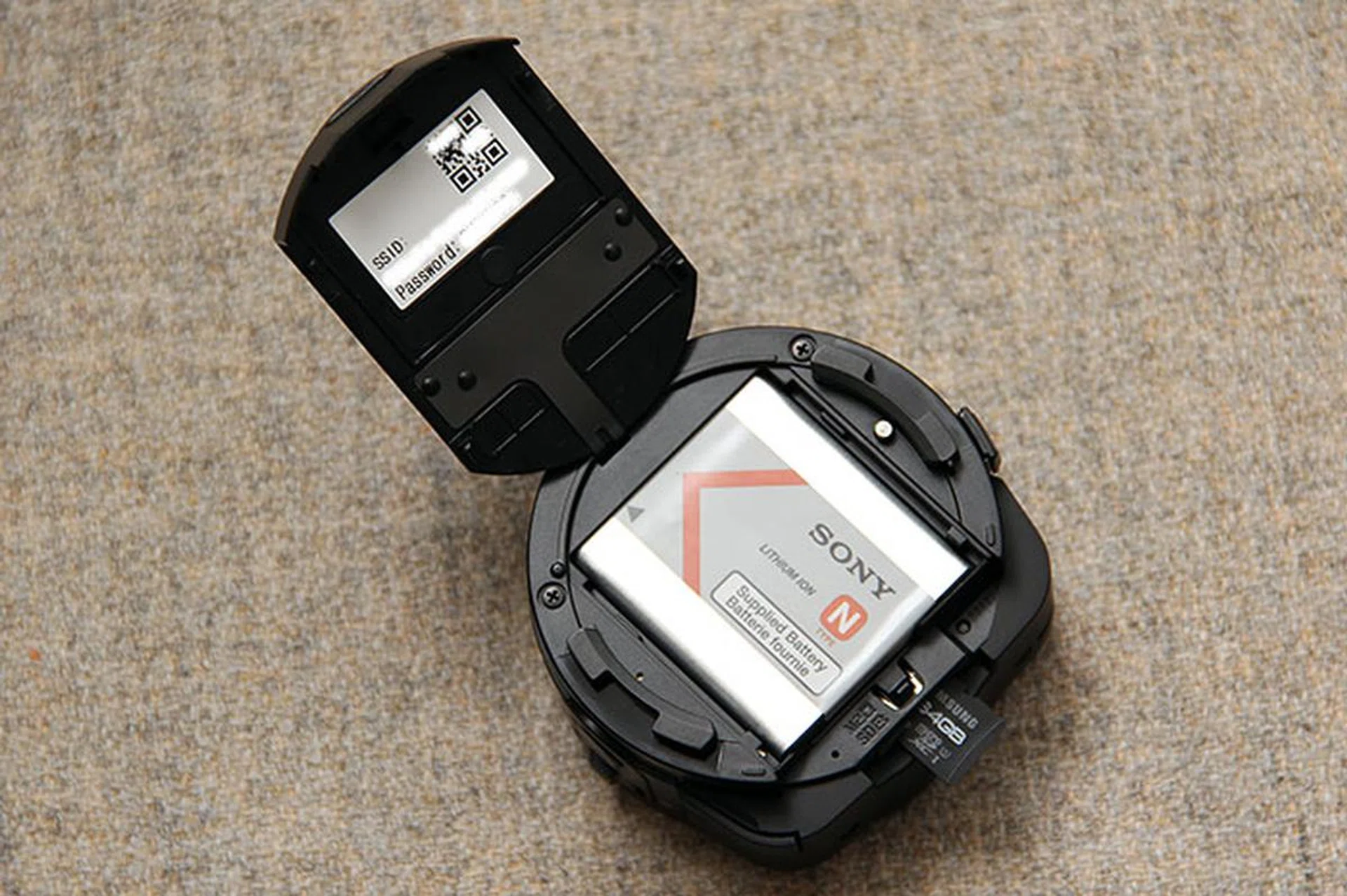 A 630mAh battery is used to power the QX10. The microSD/Memory Stick Micro card slot is also found under the compartment door.