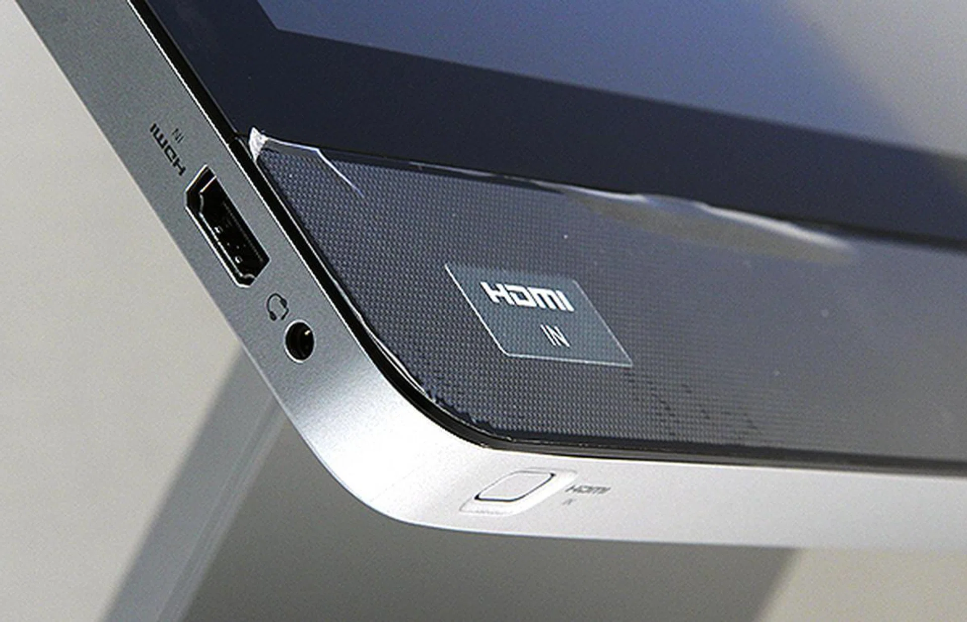 On the bottom left hand corner there is a HDMI input port and headphones jack. The button below switches the display source to HDMI.