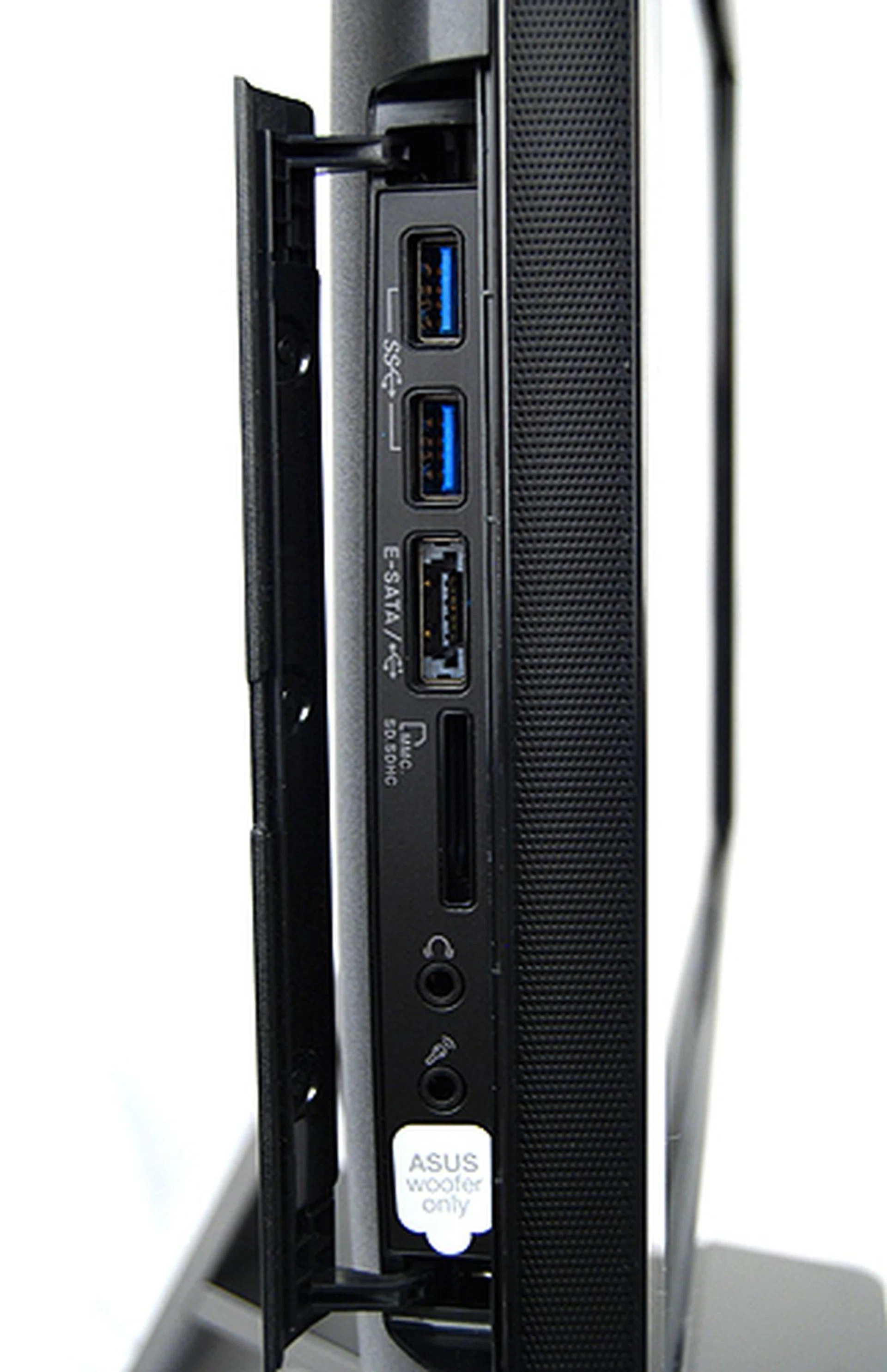 To the left of the display, behind a cover, lies two USB 3.0 ports, an eSATA/USB combo port, a memory card reader, a microphone jack and audio jacks for headphones/speakers and ASUS' own SonicMaster subwoofer.