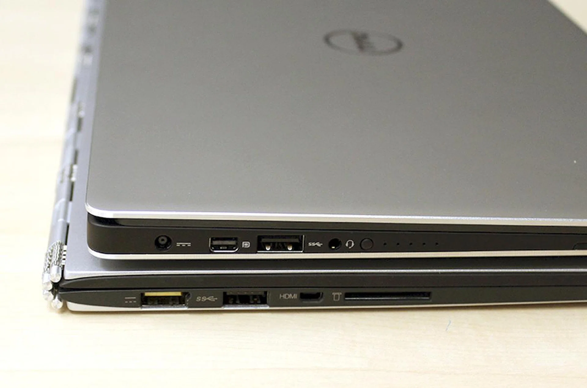 The Dell XPS 13 is 15mm thick, whereas the Lenovo Yoga 3 Pro is 12.8mm. There's really not much difference between the two.