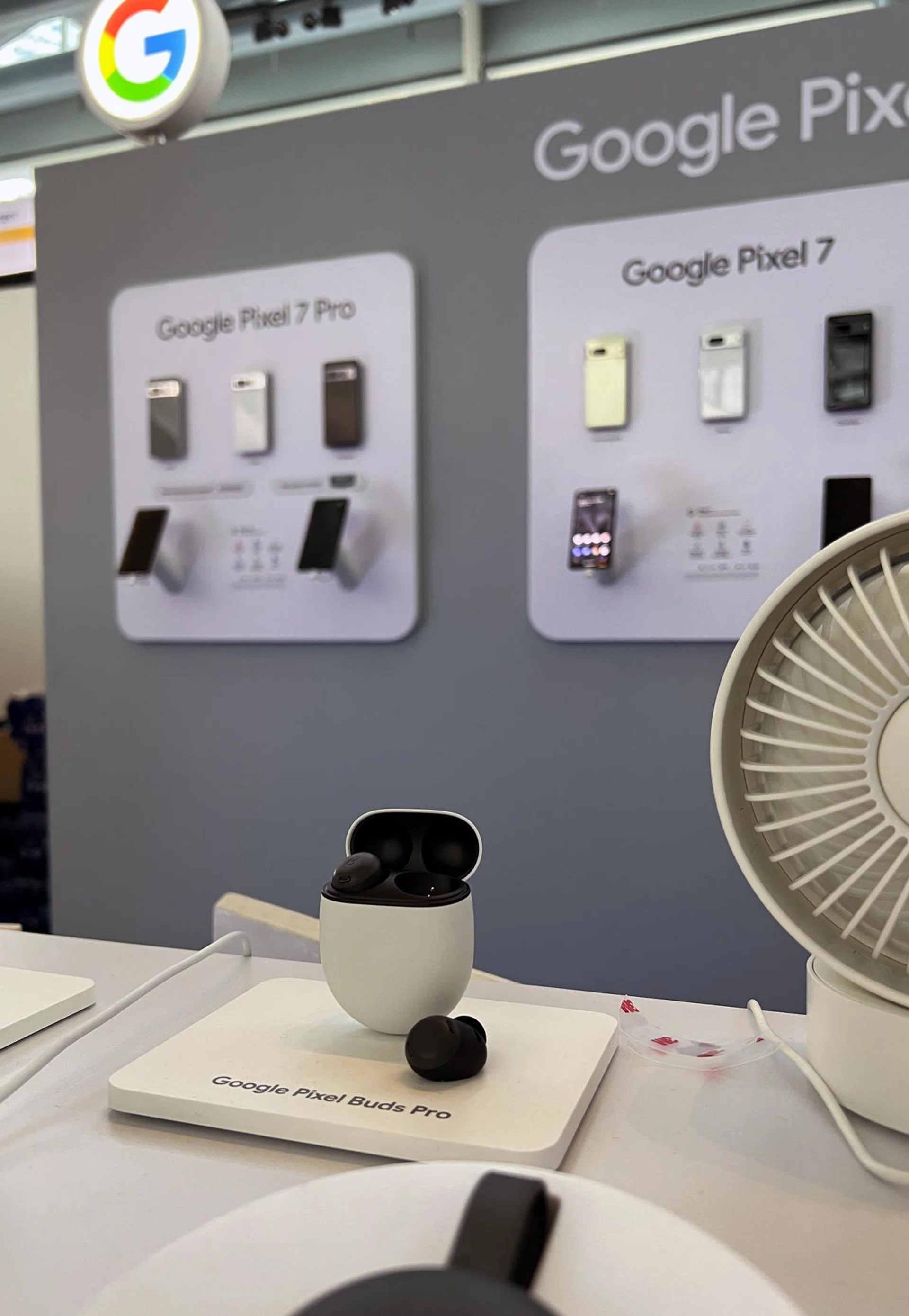Google Pixel Buds Pro (foreground).