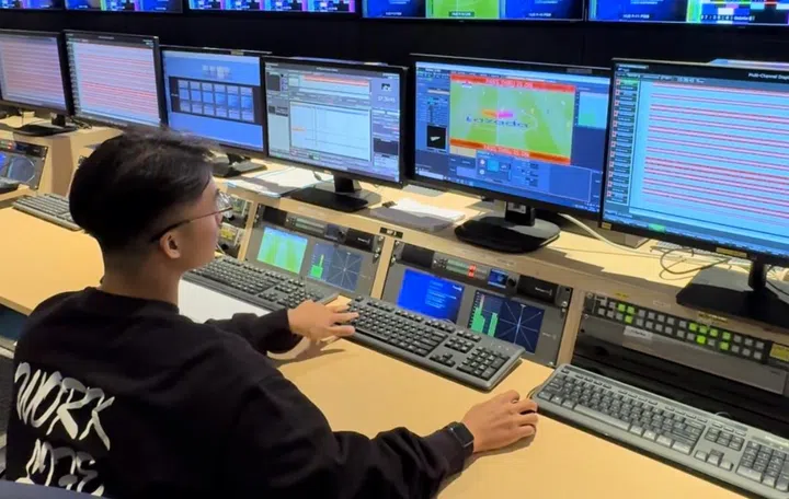 One of the staff from Encompass Digital Media showing how they add advertising during a live match. 