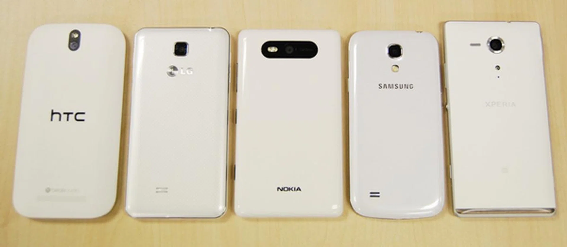 The rear shot of the five phones. <br> From left to right: HTC One SV, LG Optimus F5, Nokia Lumia 820, Samsung Galaxy S4 mini, Sony Xperia SP.