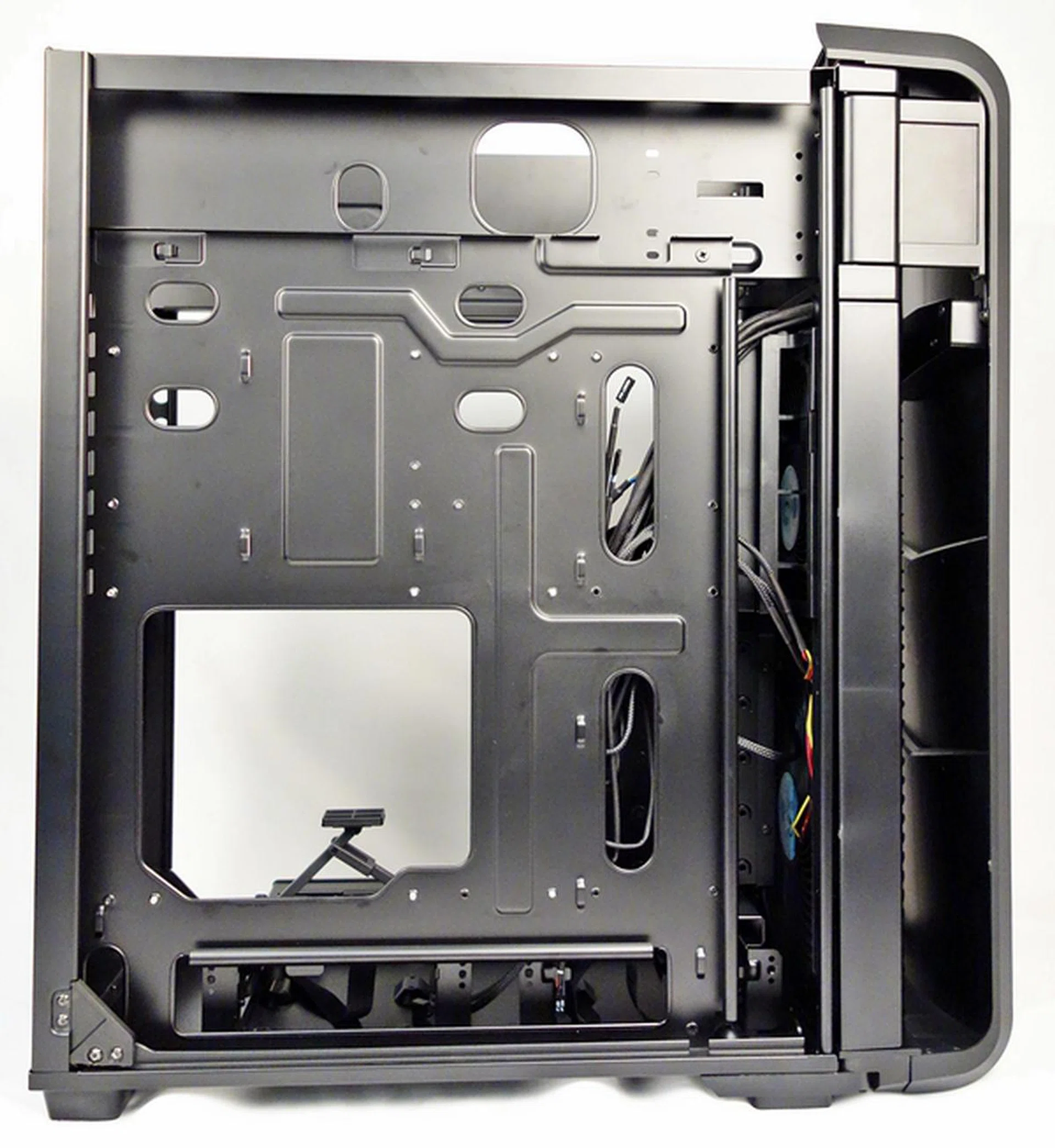 The removable motherboard tray of the Raven RV04 features a large number of cut-outs.
