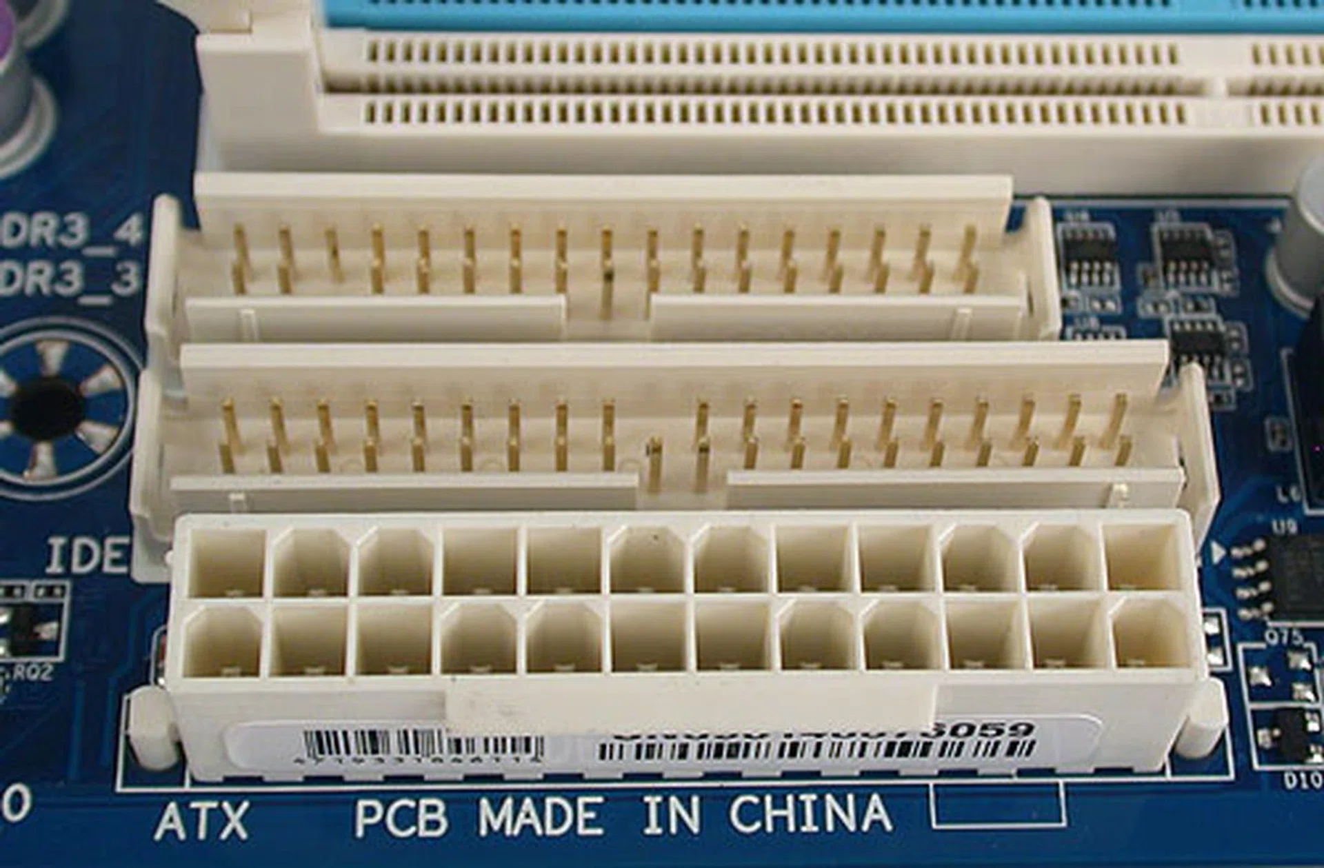 Gigabyte certainly is out to ensure that everything's covered by squeezing in floppy and IDE connectors here between the DIMM slots and the 24-pin ATX power connector.