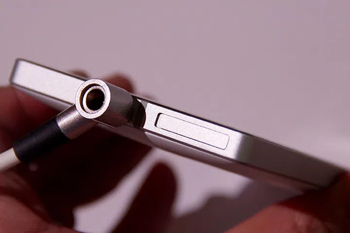 The SIM card tray is in a slot located at the top; no ejection pin needed.