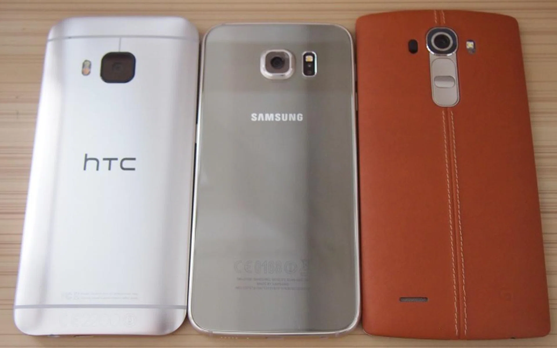 From left to right: HTC One M9, Samsung Galaxy S6, LG G4. <br> Metal, glass, leather - what's your pick? 