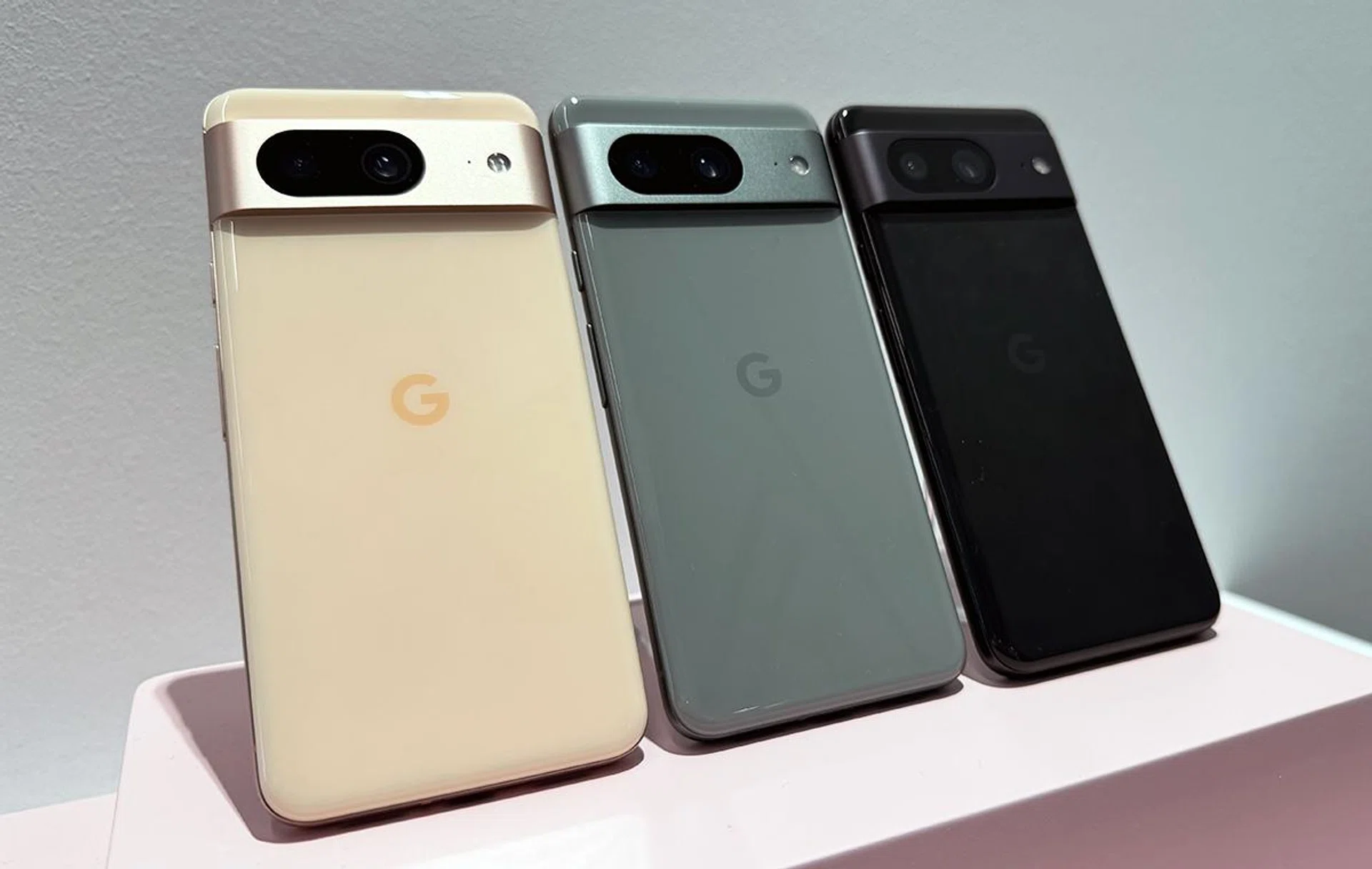 Google Pixel 8 in Rose, Hazel, and Obsidian (left to right).