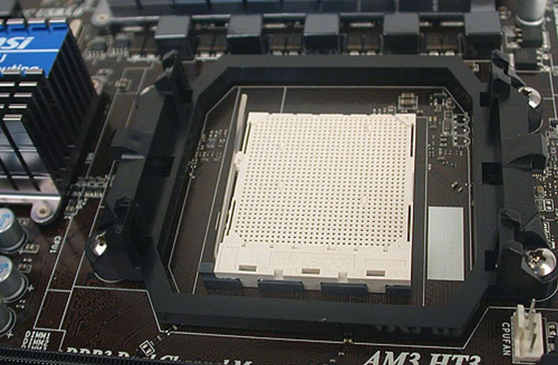 The standard AM3 socket, with sufficient clearance for most coolers. At least we had no issues with our third-party cooler. 