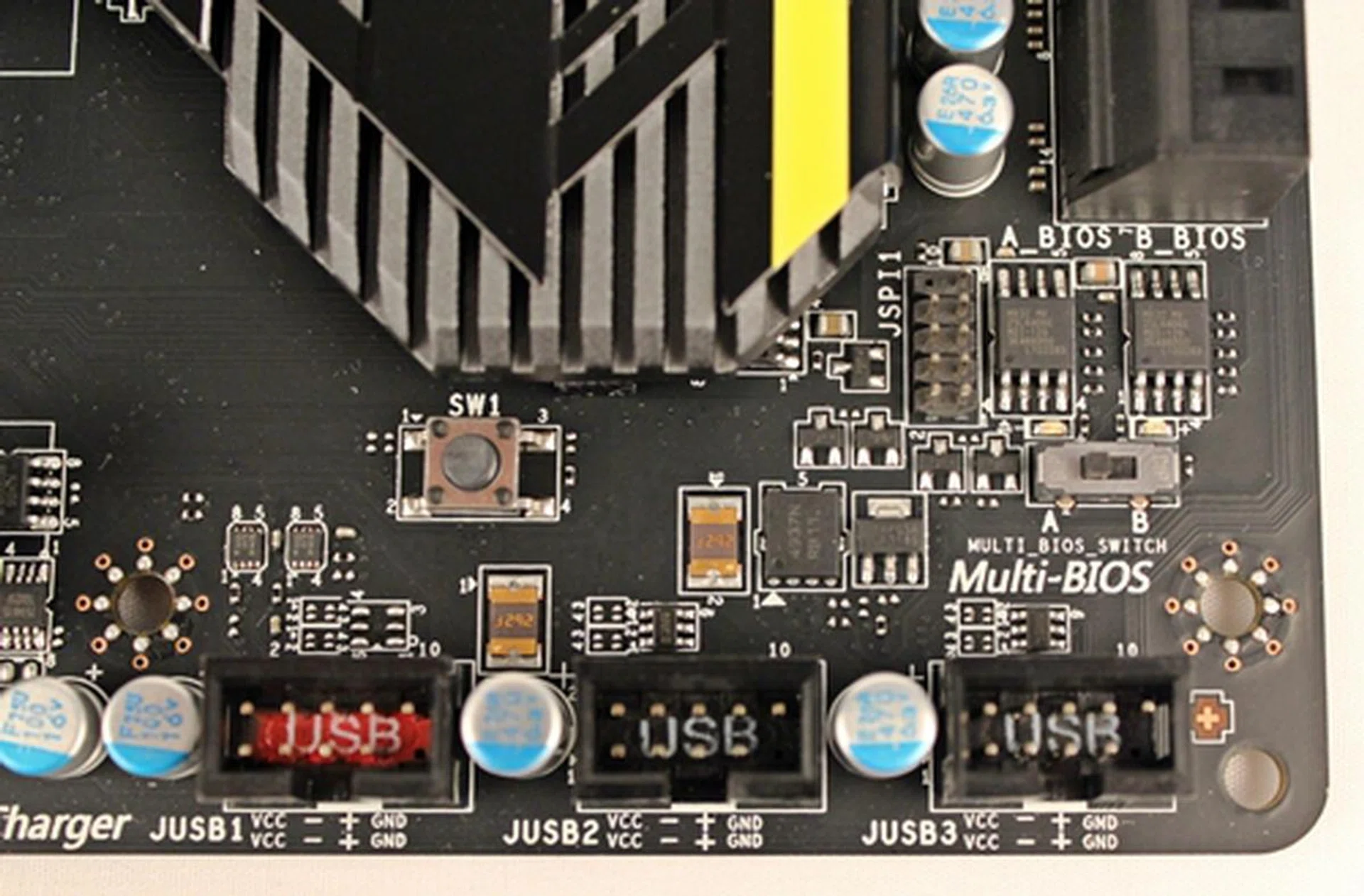 There is a Multi-BIOS switch located next to the set of SATA 3Gbps connectors. The SW1 button is the GO2BIOS button that will force the board to boot to its BIOS selection menu when it is pressed.