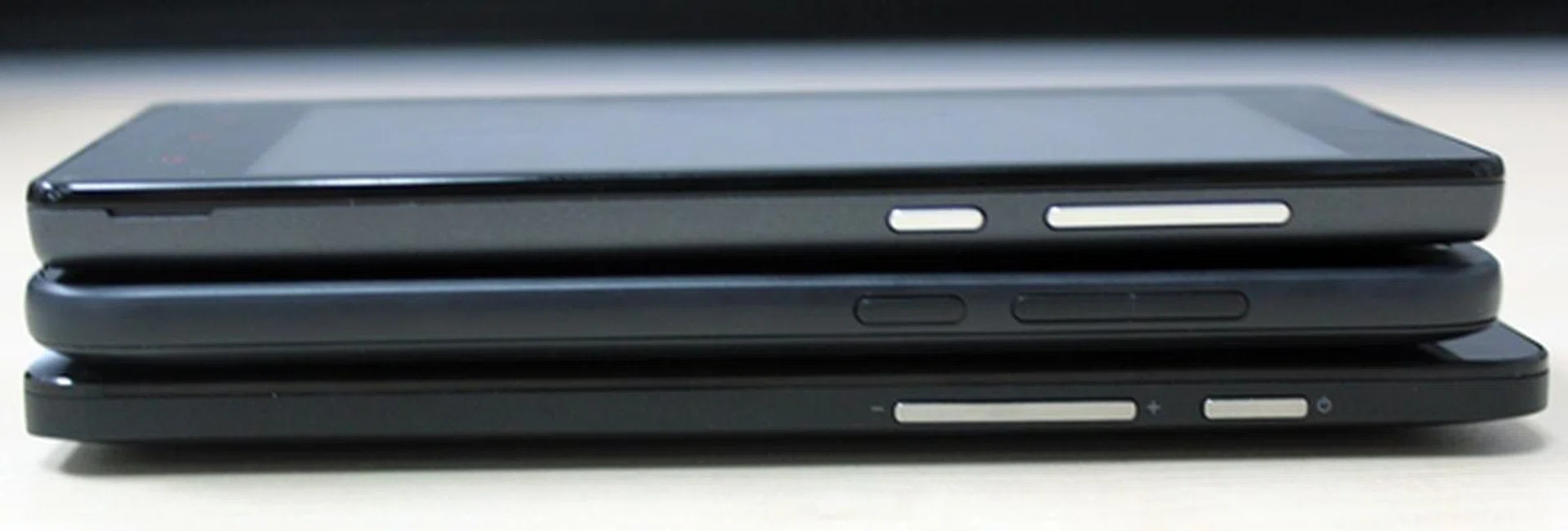 The right side profiles of the three phones. <br> Top to bottom: Xiaomi Redmi 1S, HTC Desire 616 and ASUS ZenFone 5.