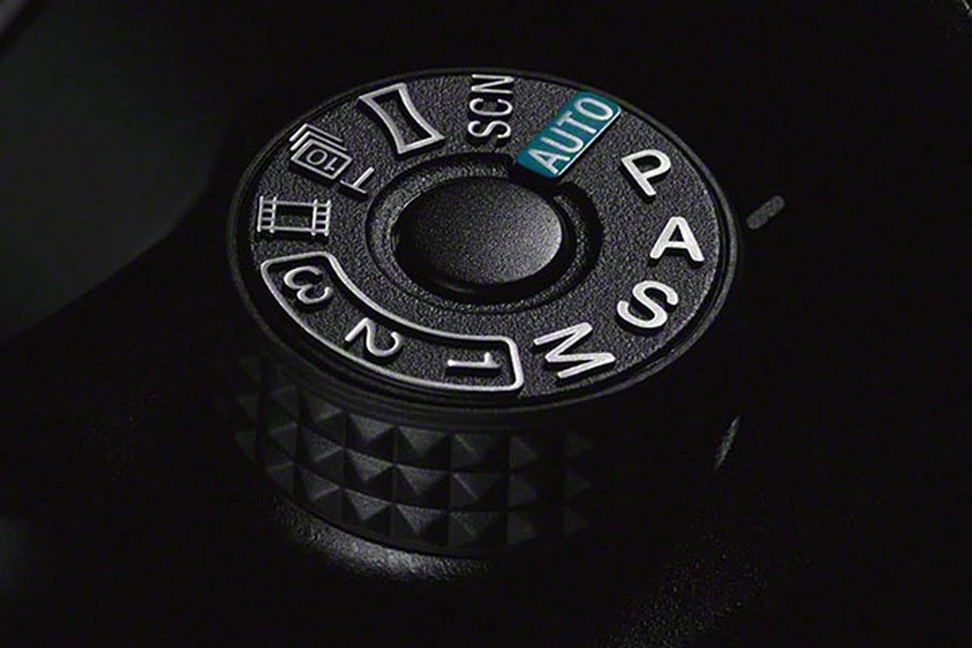 Notice that the mode dial has a lock button. You need to press it down before you can turn the dial. 