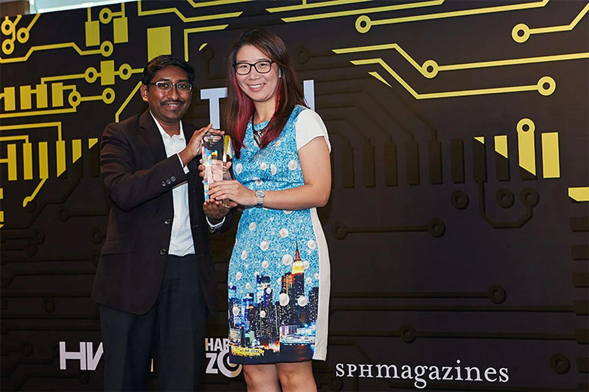The Nikon D750 emerges victorious in our Best Semi-pro Interchangeable Lens Camera category. Here's Ms. Samantha Chan from Nikon accepting the award.
