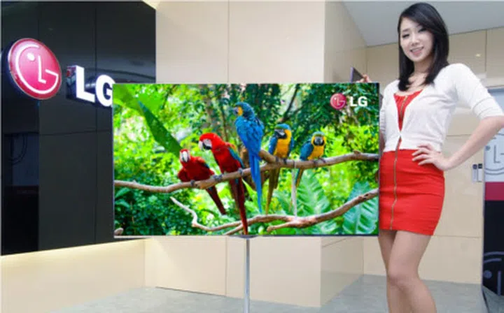 The 55-inch OLED TV on its long floor standing base.