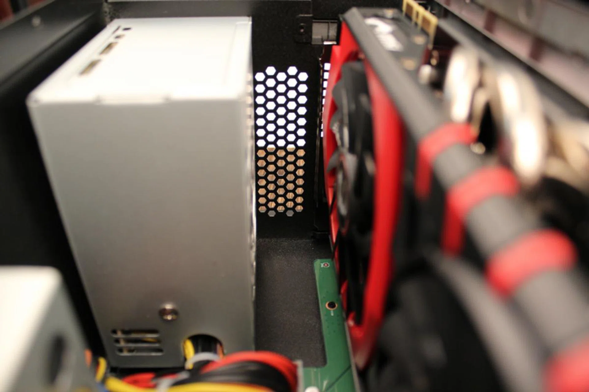 This is a close up view of the space between the PSU and the graphics card. An ATX PSU won't fit in there given the small confines.