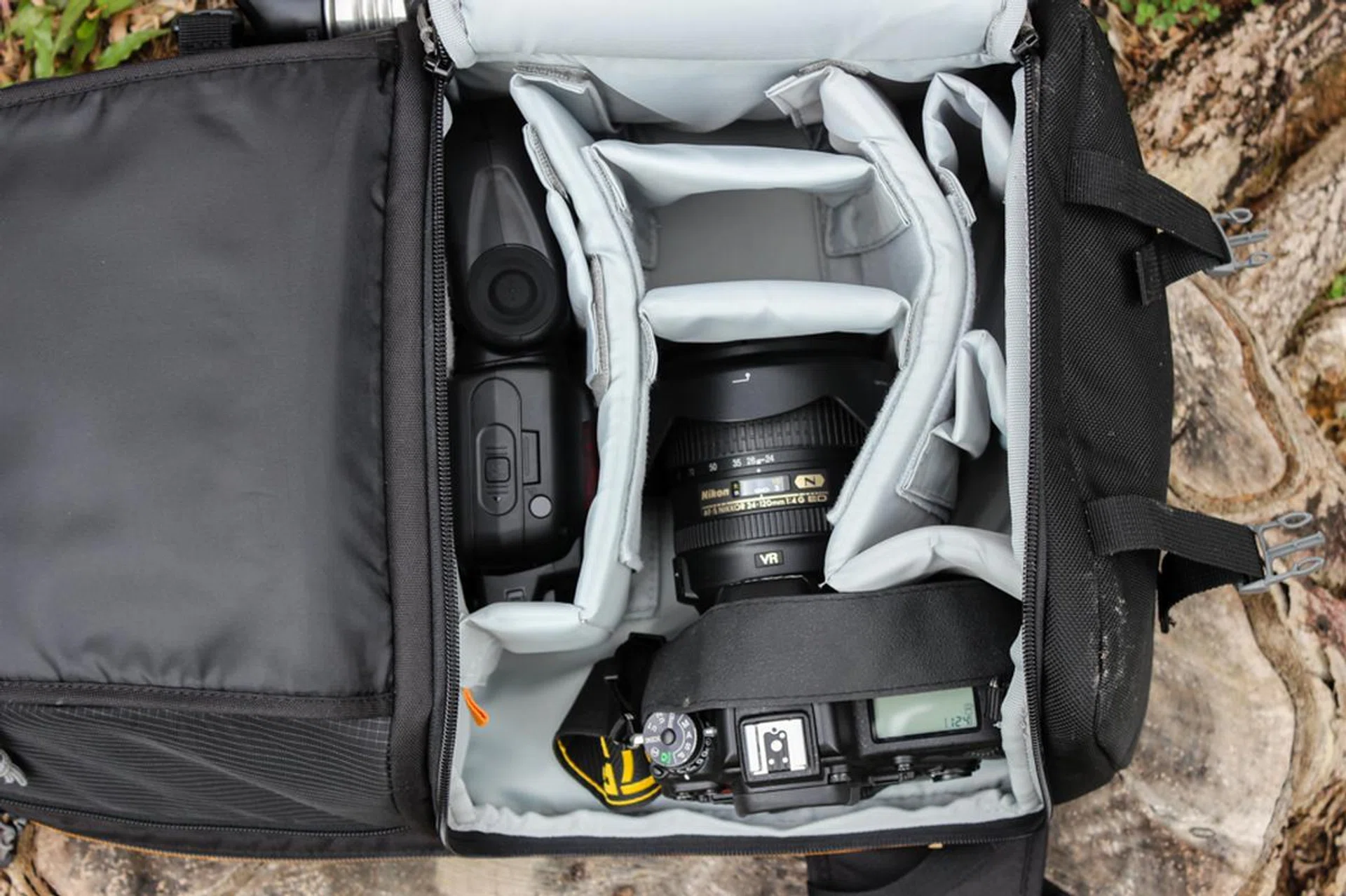 Sample carry: A Nikon D750 and SB-910 Speedlight. I can comfortably stash a mid-range prime next to the camera, and possibly squeeze a telephoto along the bottom.
