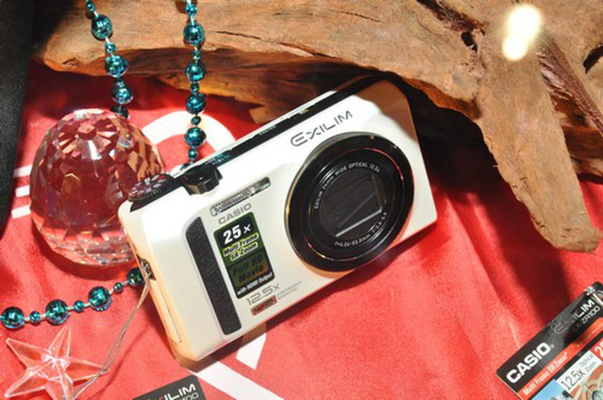 The brand-new EX-ZR100 is going for $599, it does a long 12.5x optical zoom with a 24mm wide lens.