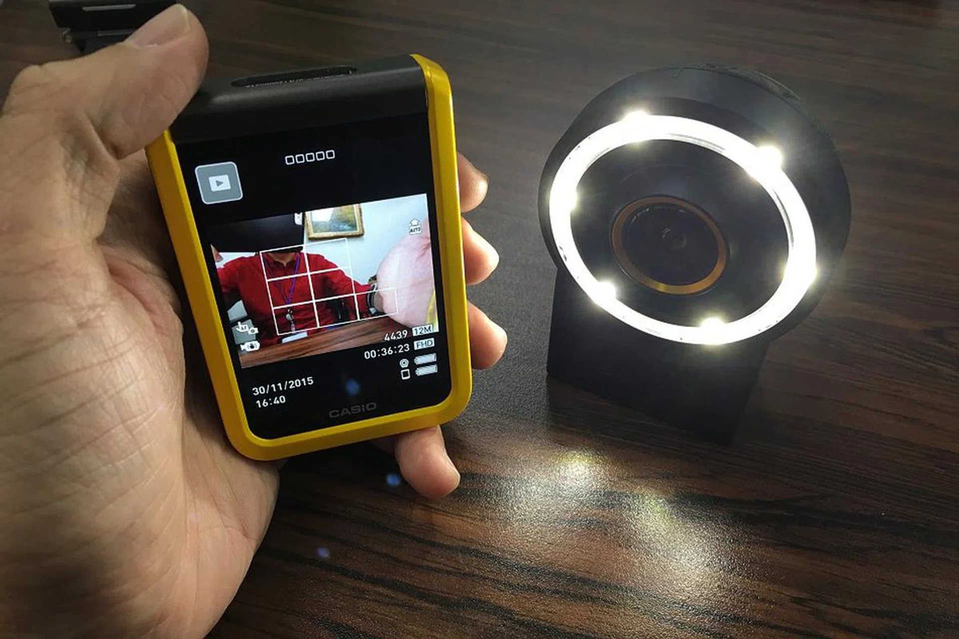 This is the LED ring flash attachment for the Exilim FR100. Costs $99 and utilizes 2 x AAA batteries (which aren't included).