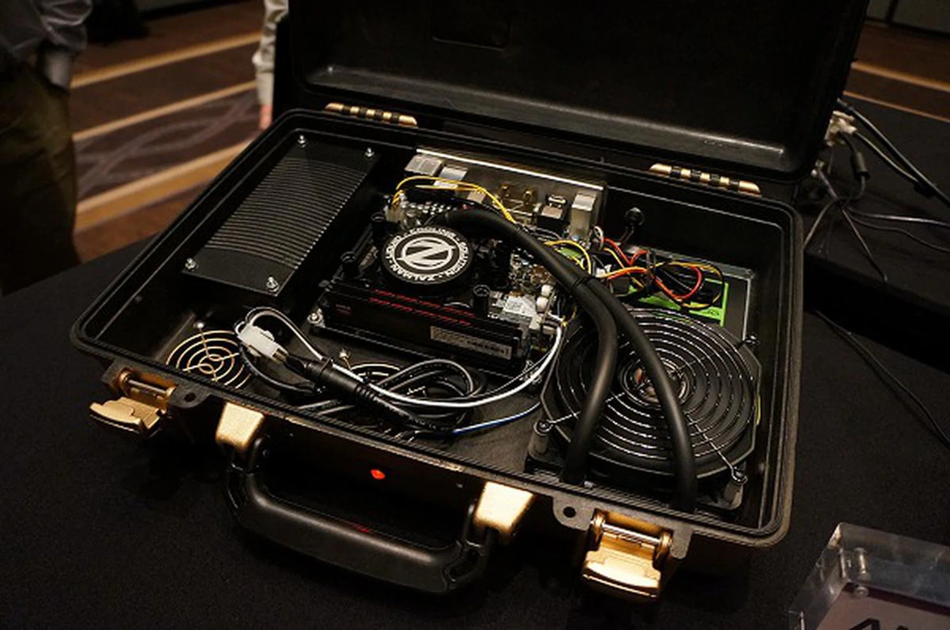 The briefcase PC is actually a custom PC-mod. With the advent of SSD drives, couriering over a briefcase PC overseas is certainly a feasible idea.