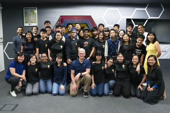 Jia Chen during a meet with Apple CEO TIm Cook. Jia Chen is third from left in the back row in spectacles. 