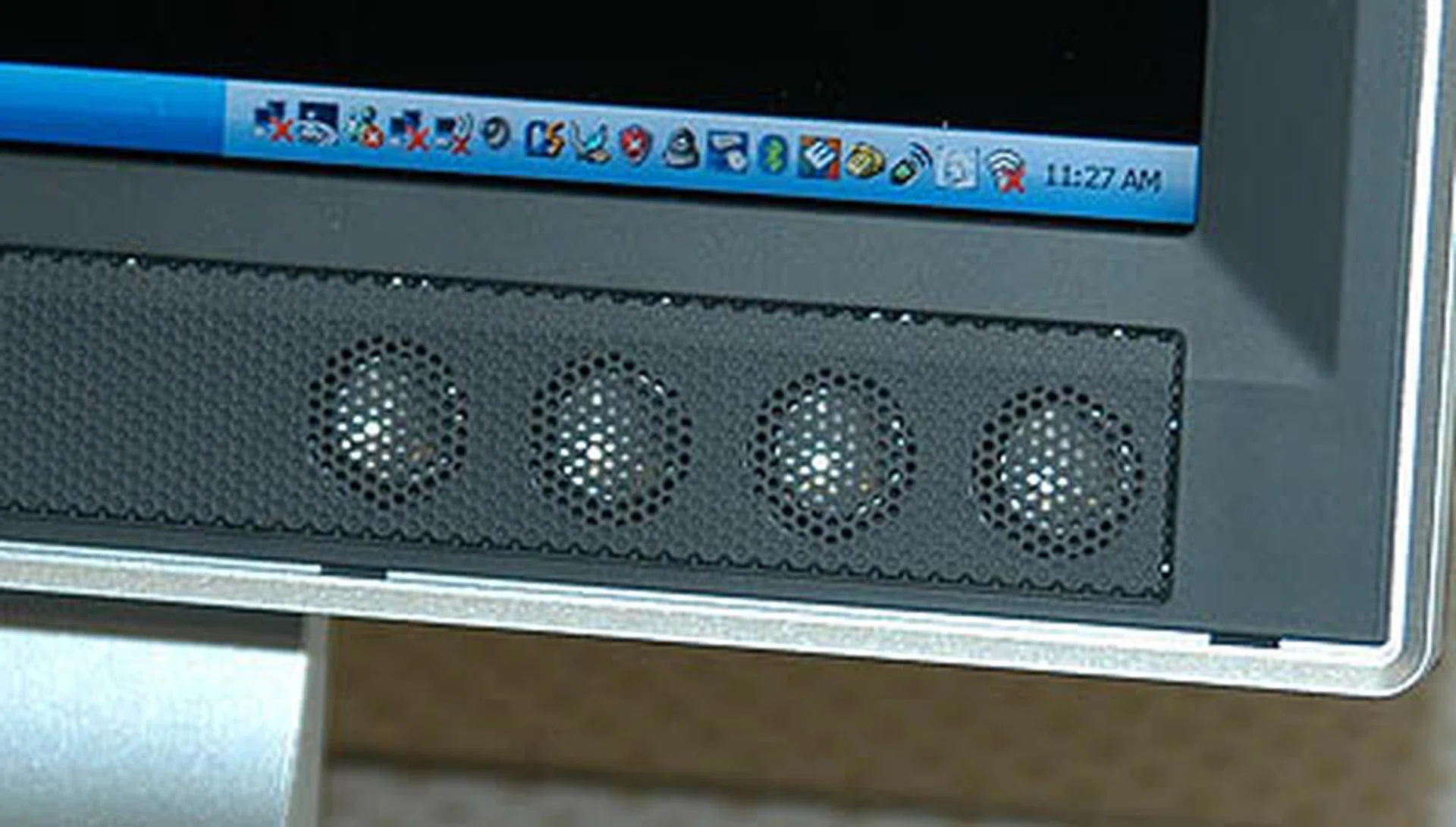 The system has two sets of 4 speakers below the LCD display (one set on each flank of the screen).