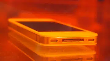 The Apple iPhone is immersed fully in the water with its ports "exposed" to water, yet it is still usable thanks to DayWired 101X nano-coating.