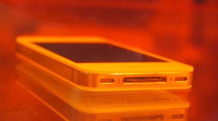 The Apple iPhone is immersed fully in the water with its ports "exposed" to water, yet it is still usable thanks to DayWired 101X nano-coating.