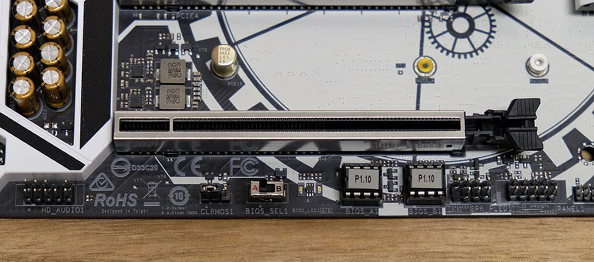 The dual BIOS chips and switch selector are located along the bottom of the board.