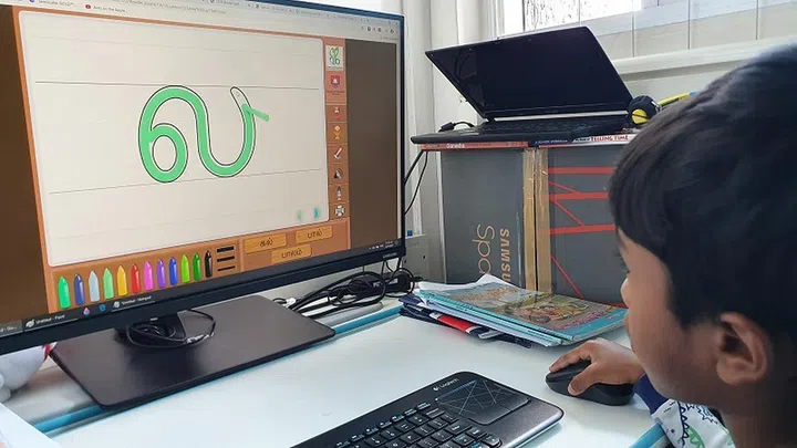 Getting familiar with his Tamil letters through colouring games that help cultivate the stroke needed to write it fluidly.