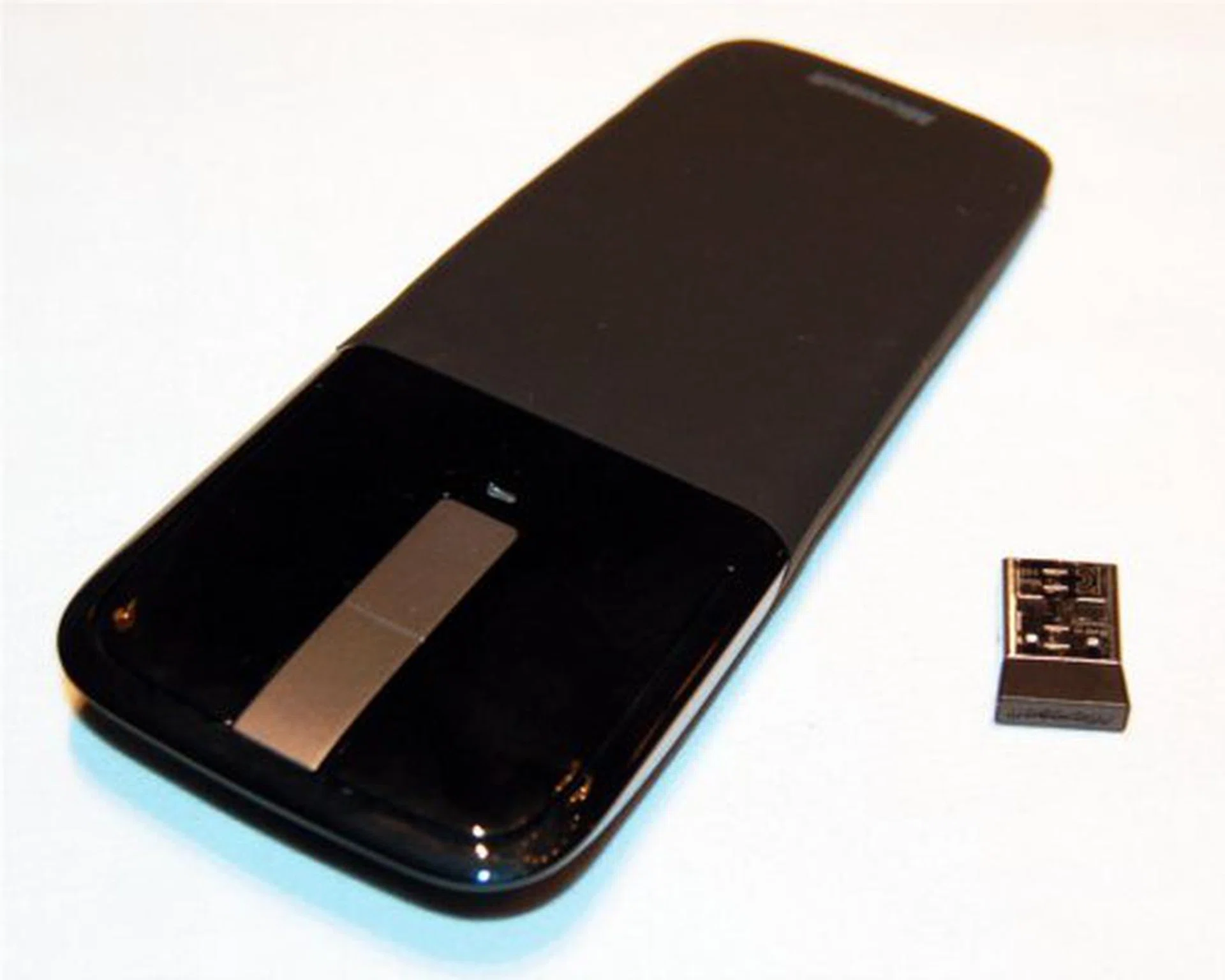 The Arc Touch mouse with its USB dongle for wireless connectivity.