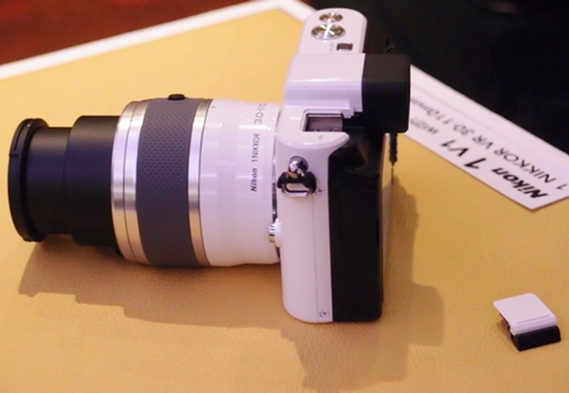 Some of the additional features that the V1 has over its smaller sibling is a multi-accessory port (seen here with the protective cap taken off). The new Speedlight SB-N5 and GP-N100 are examples of V1-dedicated accessories that can be mounted on the camera. Noticeably missing on the V1 is a built-in flash. 