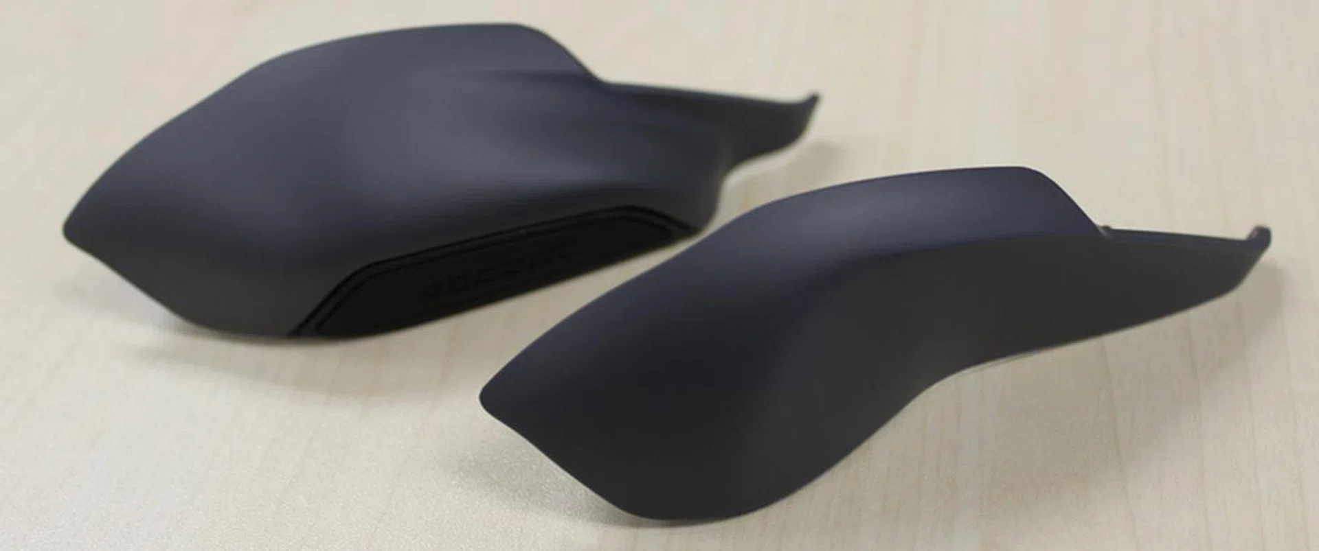 The bigger sidegrip (on top) has a finger rest, while the smaller one doesn't.