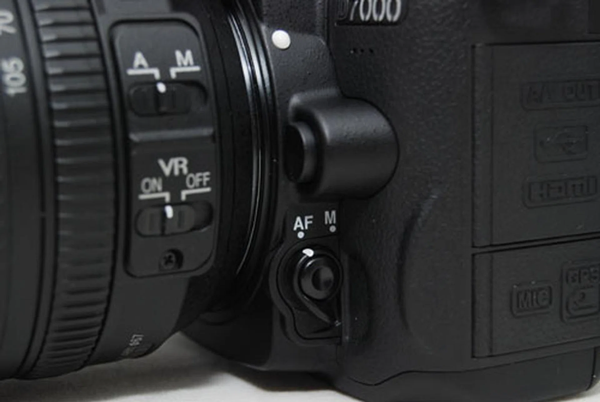 If you want to switch auto-focus modes, you've to reach for this unmarked button on the AF/M lever. What an odd position to place such a crucial button!