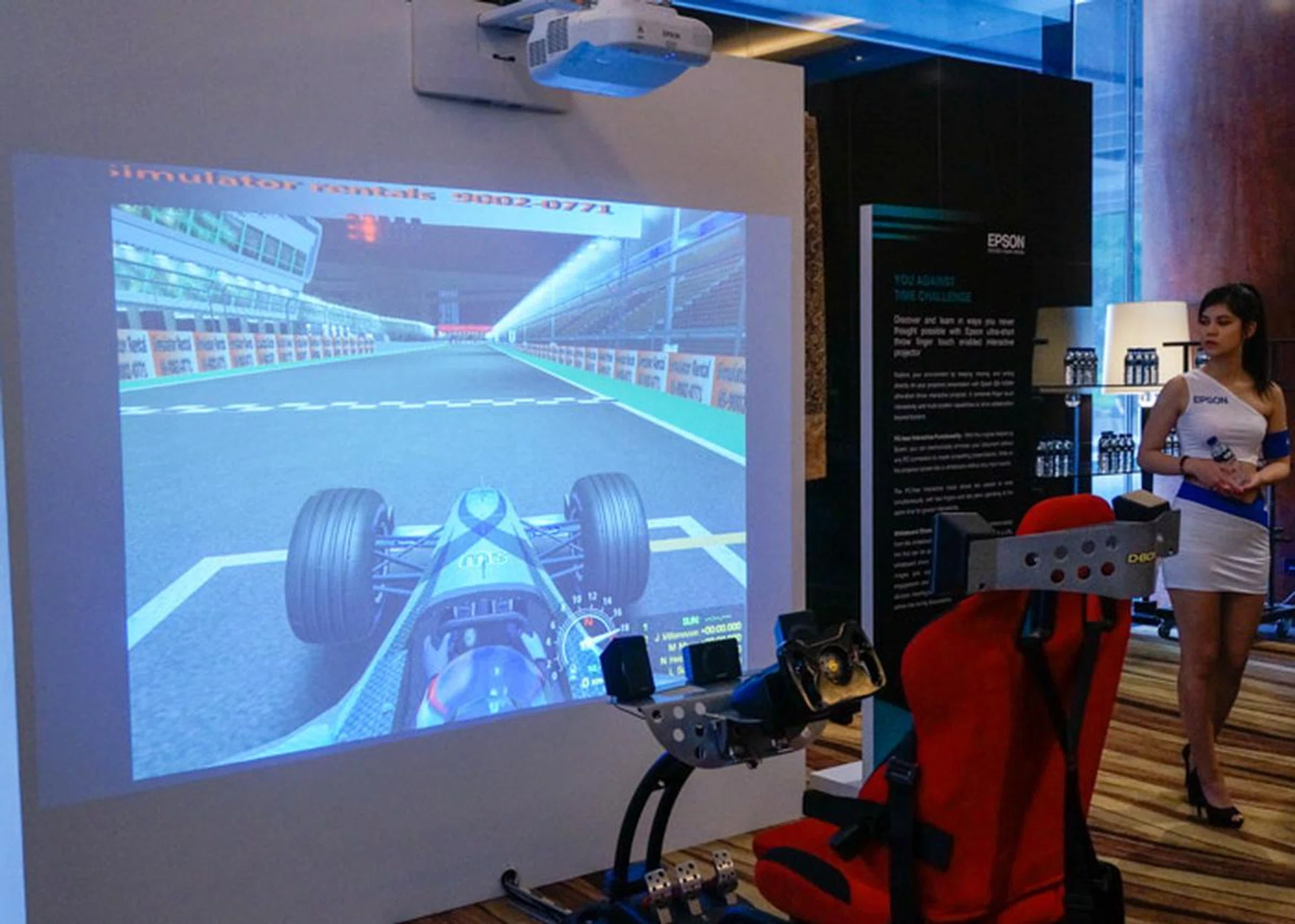 An Epson short-throw projector was used on a blank wall to form a massive screen for the racing simulator.