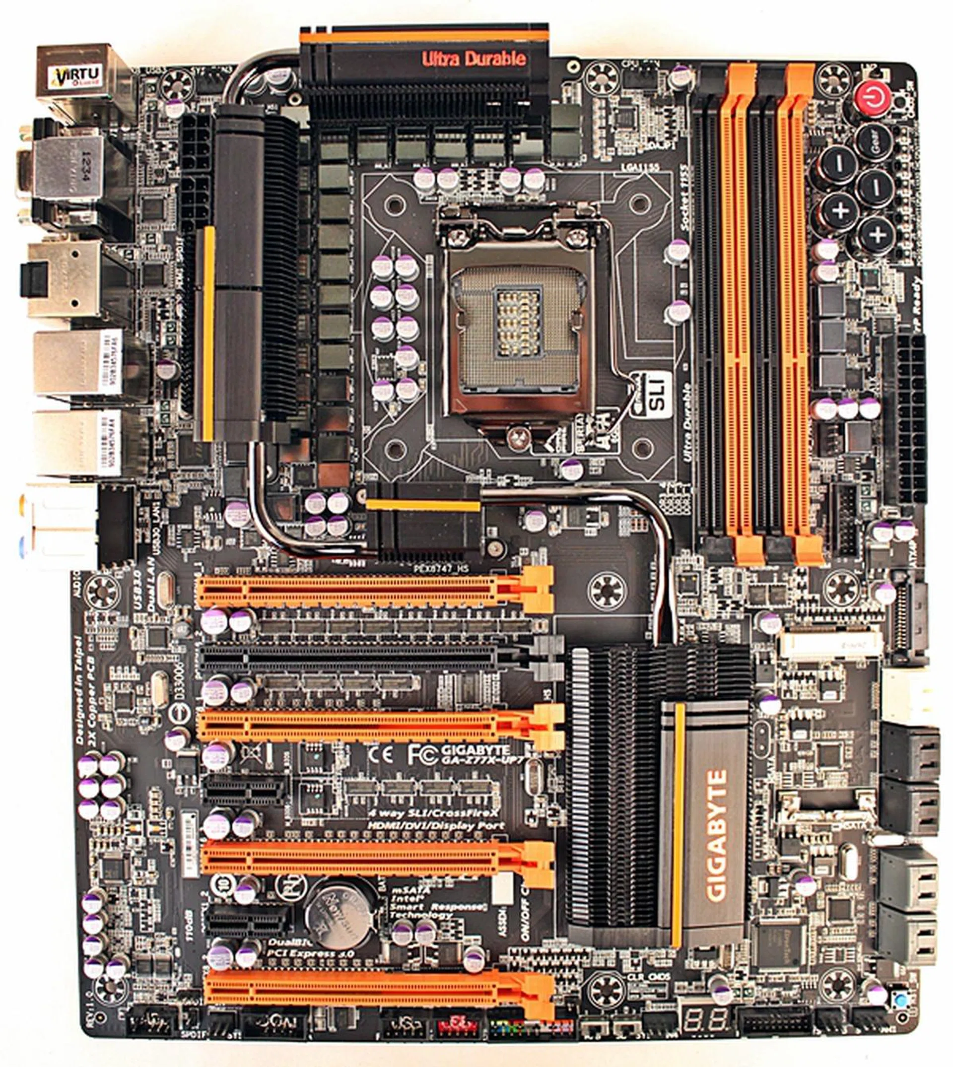 The Gigabyte GA-Z77X-UP7 motherboard is an aesthetically glaring board with its bright orange streaks set against its black PCB. The sheer amount of its feature set at first glance is enough to set our minds reeling. From its onboard OC buttons to its VRM cooling system that has been linked by a snaking silver heatpipe, the board is practically bursting at its seams with various onboard components!