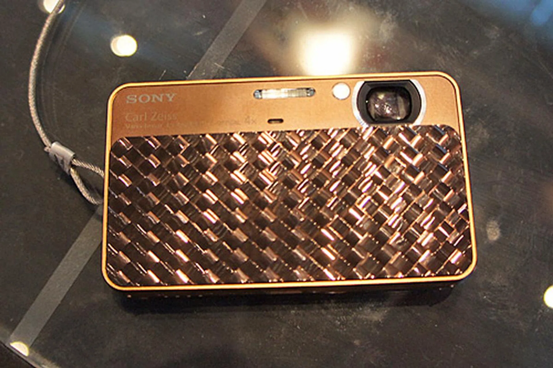 The Cyber-shot T99 has a 14.1-megapixel sensor, a 4x optical zoom lens, and a 3.0-inch LCD. It also shoots 720p video. It's selling for $329 (usual price is $449). Freebies include two 8GB SD cards, Sony DVD player, case, mini tripod, and screen protector. Shown here is the T99D which is a special brown color version. 